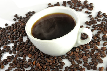 cup with coffee on a background of coffee beans