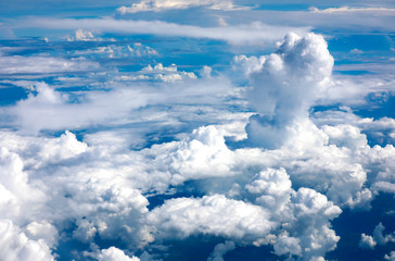Naklejka na ściany i meble Beautiful white clouds with blue sea background taken from a plane