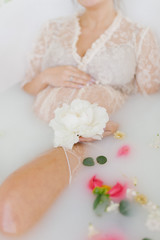 pregnant woman in a bath with flowers