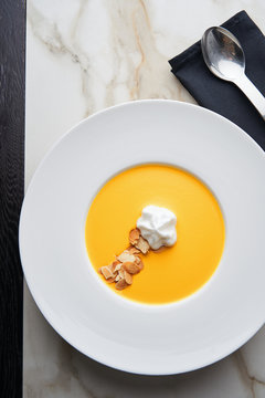 Gourmet puree of carrot soup with whipped coconut cream
