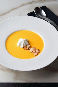 Gourmet puree of carrot soup with whipped coconut cream