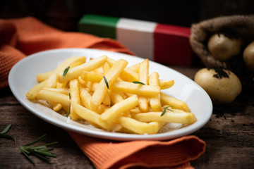 Fresh homemade fries on old wooden table
