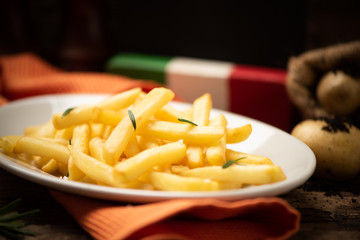 Fresh homemade fries on old wooden table