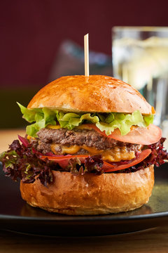 Classic American cheddar cheeseburger in brioche homemade hamburger bun
