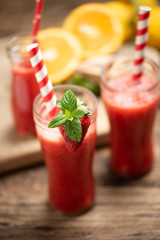 Strawberry smoothies decorate with fresh fruits on wooden table