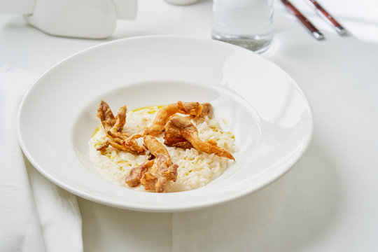 Creamy mascarpone risotto with oyster mushrooms on white table