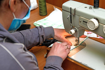 Sewing medical masks at home. Sewing on a sewing machine