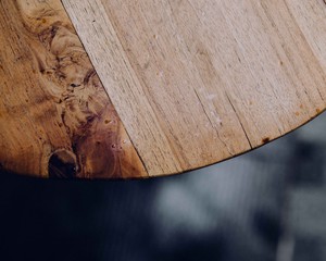 Wooden table seen from above. Dark elegant.