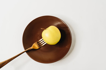 Healthy diet. Weight control. Apple on fork against white background. Healthy food concept. 