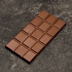 chocolate bar with nuts on a dark background