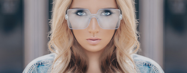 Beautiful stylish blonde woman in blue sunglasses in outdoor. Banner photo.
