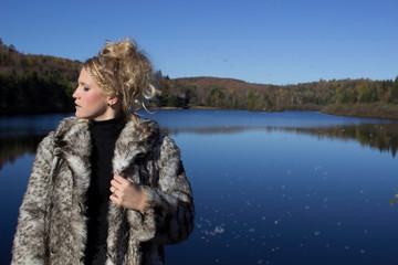 women fashion fur coat in forest