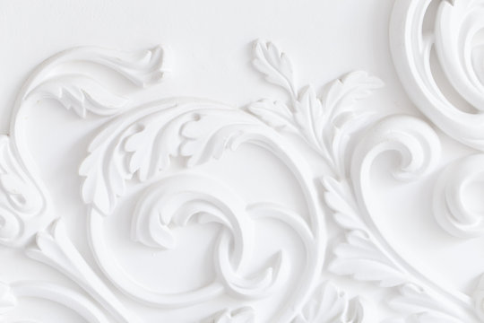 Beautiful ornate white decorative plaster moldings in studio.