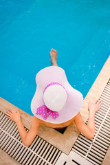 A A blower with a hat lies in a relaxation pool. On a journey