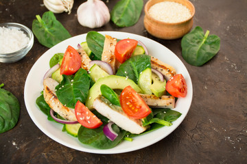 Grilled chicken breast with avocado and herbs on a dark background. Dietary nutrition. Healthy food. Side view. Close-up.