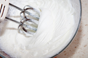 making whipped cream with a mixer in the kitchen