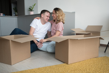 home, people, moving and real estate concept - happy couple having fun at new home.