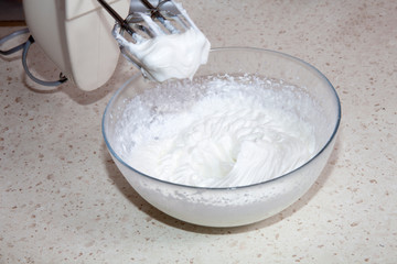 making whipped cream with a mixer in the kitchen