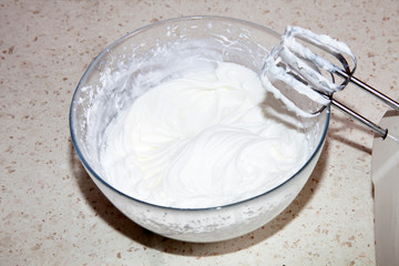 making whipped cream with a mixer in the kitchen