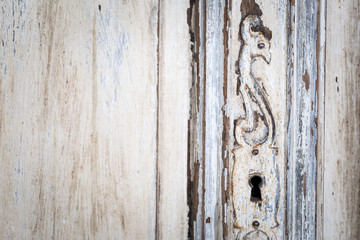 Vintage chest of drawers with carving white color with fading and metal handle. Close-up. Selective focus