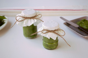 Homemade fresh pesto sauce in a jar. Selfmade preserves.