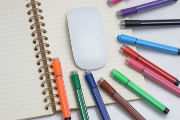 Colored marker pen, book, keyboard and mouse. concepts of home schooling and online schooling.