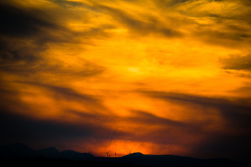 Obraz premium Wind turbines sunset