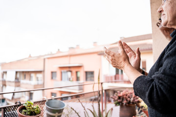 woman applauding in spain for congratulating health workers during the covid coronavirus crisis19