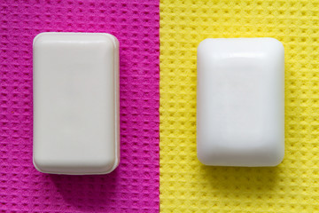 Pieces of soap for protection and prevention from bacteria and viruses on a yellow-pink surface