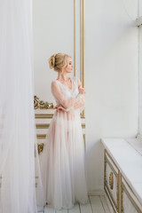 Conceptual wedding, the morning of the bride in the European style. Boudoir dress, fees in the interior Studio. White minimalism for the bride