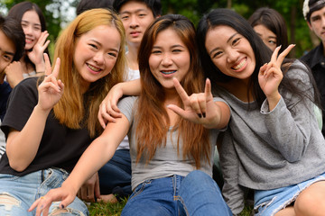 Happy young group of friends having fun together at the park