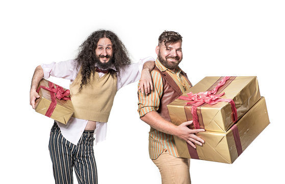 Two cheerful ners holding bunch of presents