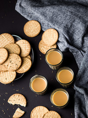 Indian chai in glass cups with metal kettle and other masalas to make the tea