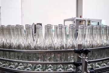 Wine production line - unlabeled bottles ready to be filled factory line