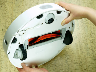 A robot vacuum cleaner cleans the floor of a house. Modern technology for comfort. Smart House....