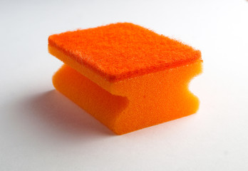 orange dishwashing sponge close-up on a white background