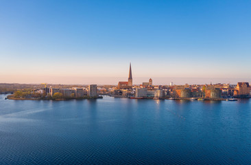 Fototapeta na wymiar panoramic view of the city of rostock - aerial view over the river warnow, skyline during sunrise in the morning 
