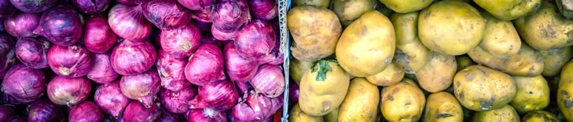 Fototapeta na wymiar Panoramic top view pile of fresh white potatoes and red shallot onions at farmer market in Singapore