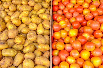 Heap of organic white potatoes and tomatoes at farmer market in Singapore
