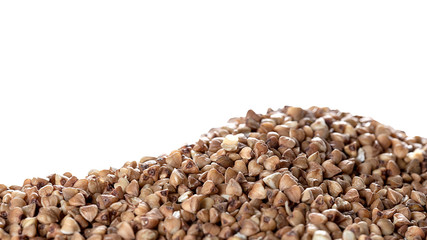 Essential goods: Buckwheat Isolated on white background. Buckwheat seed pour in bunch closeup. Buckwheat cereal background.