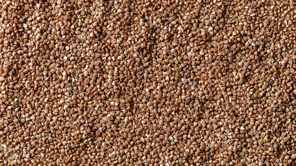 Essential goods: Buckwheat. Buckwheat seed pour in bunch closeup. Buckwheat cereal background.