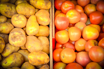 Heap of organic white potatoes and tomatoes at farmer market in Singapore