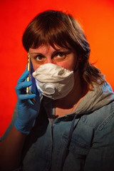 Portrait of a young woman in a medical mask with a phone.