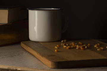 Corn kernels on a wooden table with a white metal