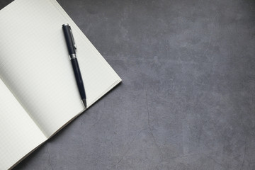 high angle view of open notepad and pen on table 