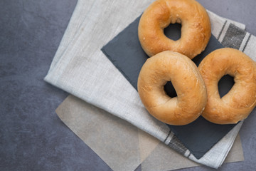 Homemade bagels on a slate plate. Top view. Copy space.
