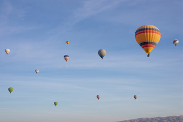 Hot air balloons flying in the blue sky in Goreme Cappadocia. Beautifull background texture. 