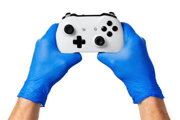 Video game console controller in gamer gloved hands. Games during isolation at home, coronavirus