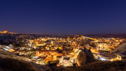 Night panorama of Goreme. Goreme at sunrise. Goreme, Cappadocia, Turkey. Famous center of balloon fligths.