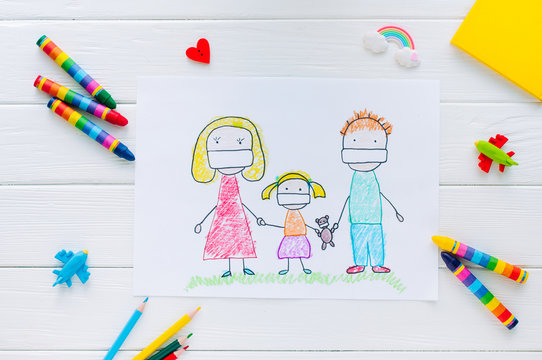 Kids picture of family in face masks on white wooden background